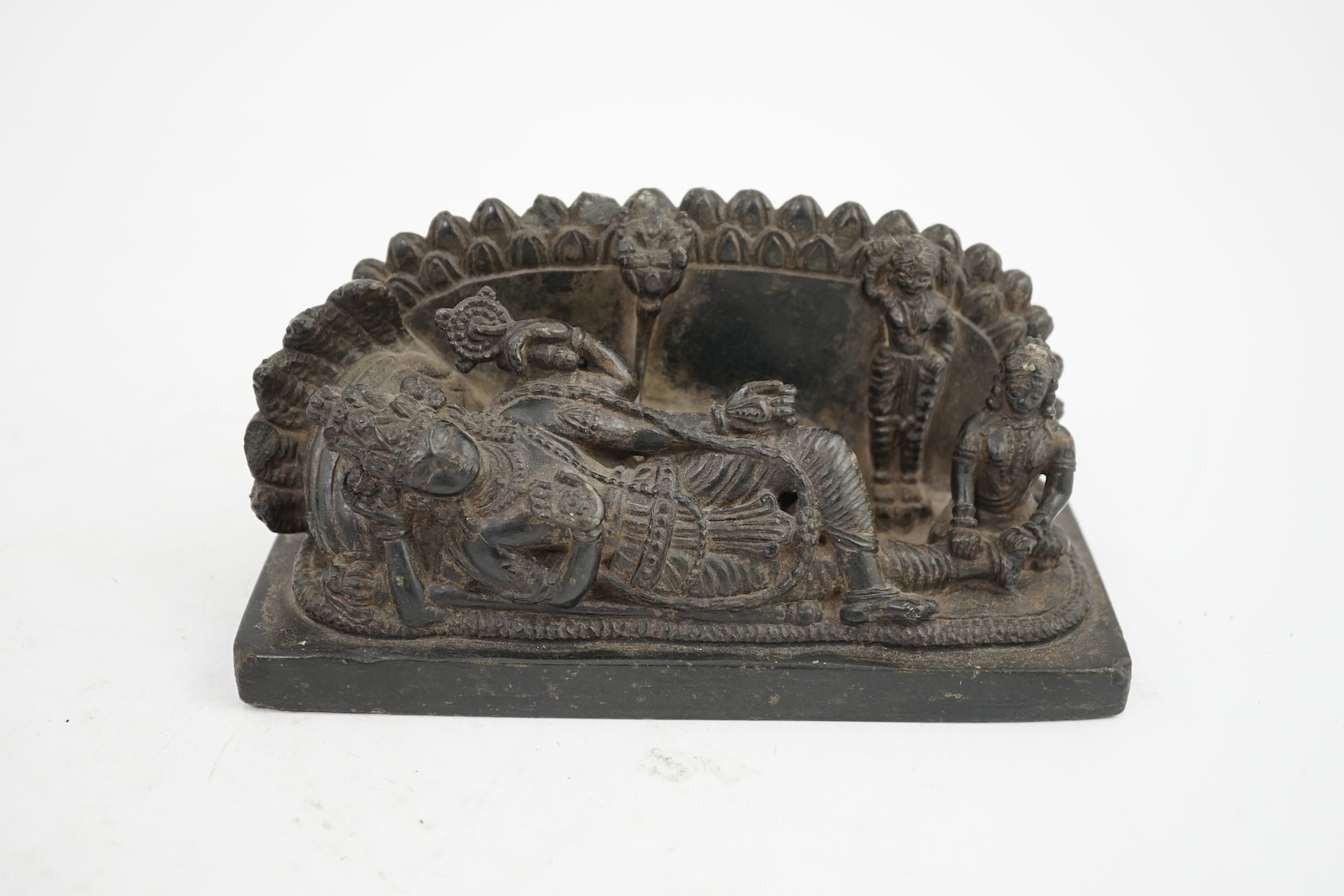 An Indian basalt reclining figure of Shiva, probably Kakatiya period, 12th century A.D